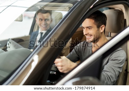 First test drive. Handsome young man ready to make first test drive Royalty-Free Stock Photo #179874914