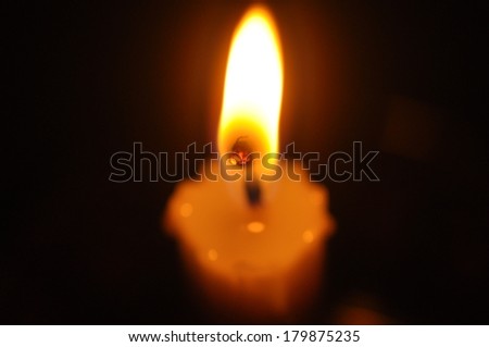 Close Up Candle With Creative Flame Over Dark Background (Noise Visible Due To Low Light Condition)