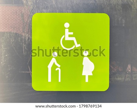 Restroom signs for Pregnant woman, Handicapped and Aged person on the restroom door at the gas station.