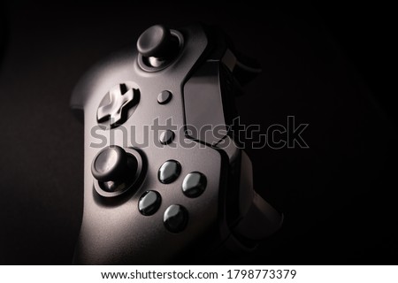 Black game controller in close view Royalty-Free Stock Photo #1798773379