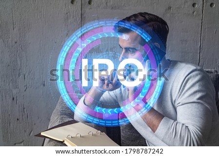 Handsome analyst in casual long sleeve talking phone, taking notes at office workplace try to analyze IPO project. Double exposure. Initial public offering hologram. Royalty-Free Stock Photo #1798787242