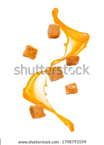 Flying caramel candies with caramel splash Royalty-Free Stock Photo #1798793599