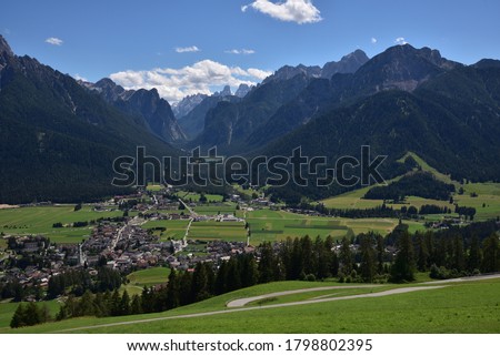 The world surrounding the town of Dobbiaco : alpine peaks, large forests and green meadows Royalty-Free Stock Photo #1798802395