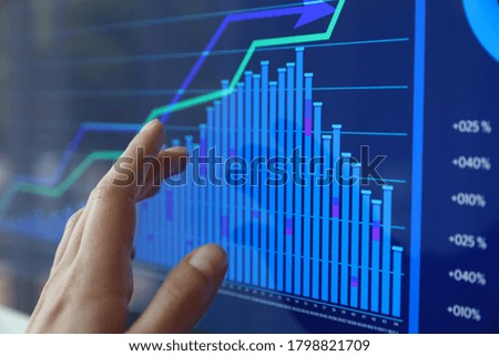 Woman working with statistic information on screen, closeup