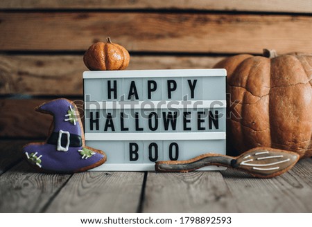 Halloween cookies for holiday. Pumpkins. Autumn mood. Happy Halloween concept. White lightbox on the wooden table.