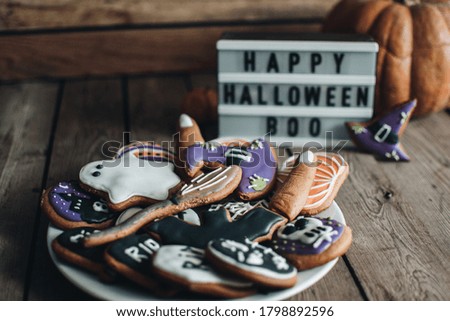 Halloween cookies for holiday. Pumpkins. Autumn mood. Happy Halloween concept. White lightbox on the wooden table.