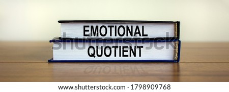 Books with text 'emotional quotient' on beautiful wooden table. White background. Business concept.