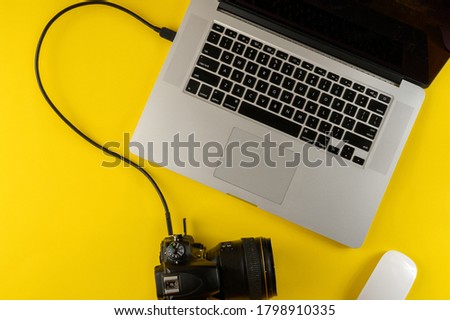 Photographer's equipment.Flat lay composition with photographer's equipment and laptop on yellow background.Photographer's workplace on a yellow background.Copy space