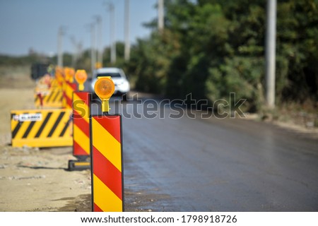 Yellow warning lights in a hazard zone during construction road works 