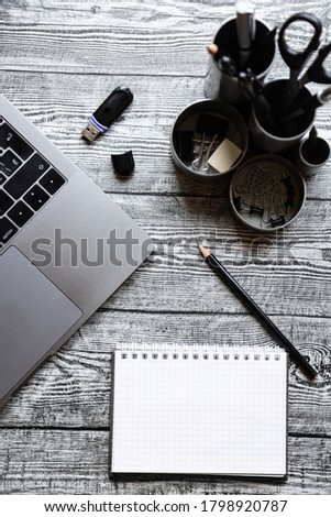 Business concept, blank notepad, pen and laptop on a wooden table. planning, finance.