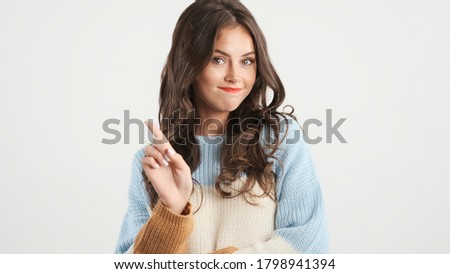 Beautiful brunette girl in sweater confidently showing no gesture on camera over white background