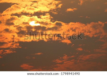 beautiful sunset orange yellow silhouette dark sky in back on the cloud
