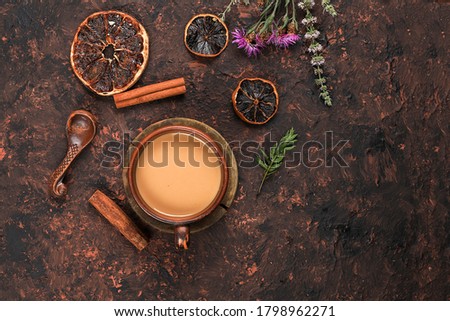 Cup of coffee with cinnamon and flowers on an old rusty table, grunge.Autumn flower arrangement, abstract background flat lay, minimal concept of holiday, thanksgiving day