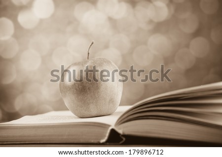 Apple and the book. Photo in old color image style