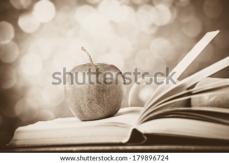 Apple and the book. Photo in old color image style