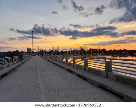 Walking over bridge enjoying a sunset