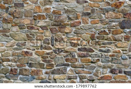 Old stone wall with different size of rock Royalty-Free Stock Photo #179897762