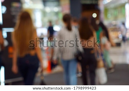 Blurred background. Shopping center gallery with people.
