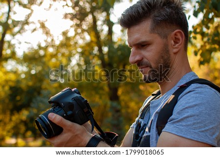 Outdoor Photographer At Work. Caucasian Men With Digital Camera