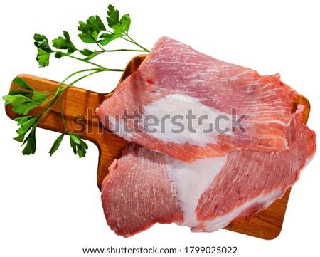 Close up of raw pork  on wooden surface with ingredients, nobody. Isolated over white background