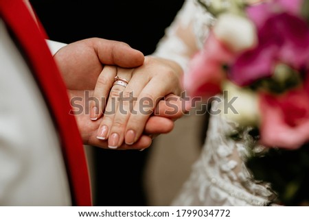 close-up hand of bride and groom, wedding rings, horizontal photo, free space for text, jewelry, hugs, loving man and woman, wedding day, bouquet of flowers