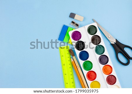 Various school supplies for education on a blue background. View from above. Education concept.