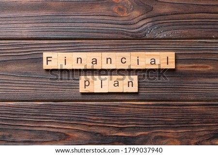financial plan word written on wood block. financial plan text on cement table for your desing, concept.