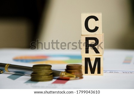 word written on cubes near financial statements and coins. High quality photo