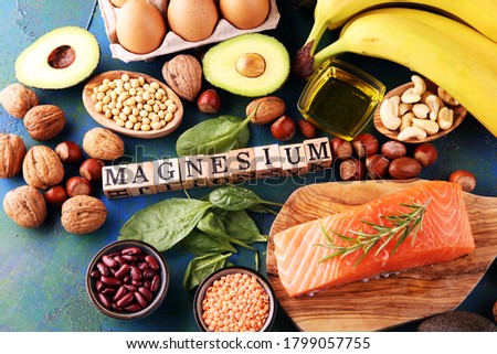 Products containing magnesium: bananas, almonds, avocado, nuts and spinach and eggs on table Royalty-Free Stock Photo #1799057755