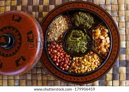 A selection of typical Myanmar snacks: tasty and spicy seeds, nuts and pickled tea leaves. Royalty-Free Stock Photo #179906459