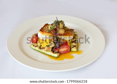 Pan-seared fish with risotto and summer vegetables