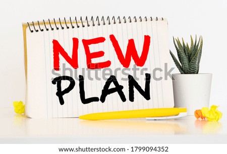 Stock photo of 2021 new year notebook with list of goals and objects on yellow background.
