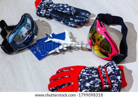 ski mask, gloves, airplane, passports on a white background