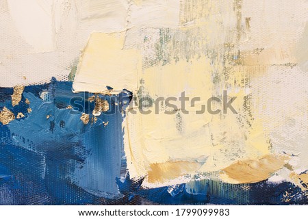 The texture of the canvas, coated with oil paints. Trendy blue and golden colors, copy space. The concept of a creative atmosphere, artistic events, education, etc.