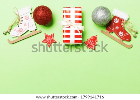 Top view Christmas ball, gift and creative decorations on colorful background. New Year holiday concept with copy space.
