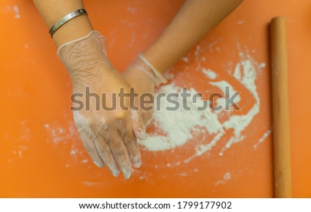 Female hands making dough for mooncake, homemade cantonese moon cake pastry on baking tray before baking for traditional festival. Travel, holiday, food concept