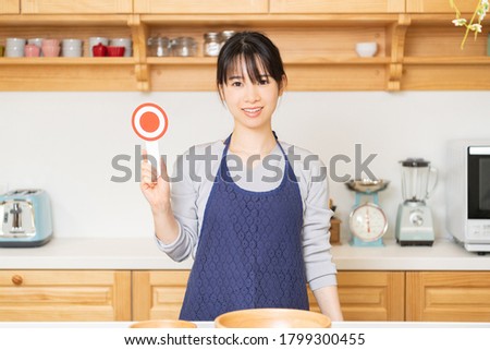 Young woman with an OK placard shot in the studio