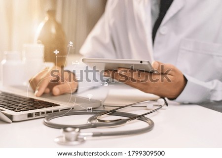 Doctor work on digital tablet healthcare doctor technology tablet using computer at office  in the morning at the desk.