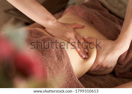 Japanese woman getting a belly massage at a beauty salon Royalty-Free Stock Photo #1799310613