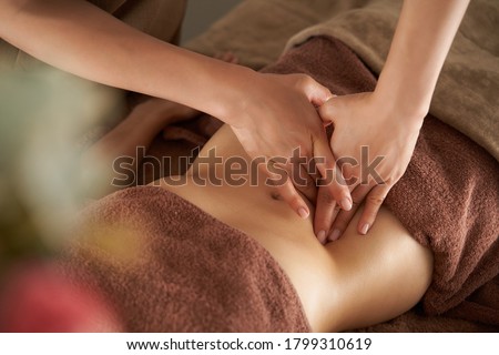 Japanese woman getting a belly massage at a beauty salon Royalty-Free Stock Photo #1799310619