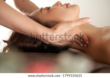 Japanese woman receiving a neck massage at an aesthetic salon Royalty-Free Stock Photo #1799310625