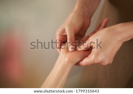 Japanese woman receiving a hand massage at a beauty salon Royalty-Free Stock Photo #1799310643