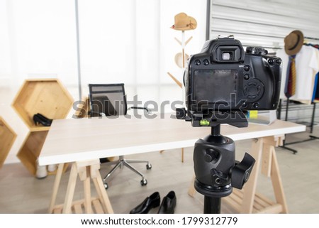 Professional camera on a tripod set up for blogger live streaming, broadcast with online internet subscribers at home office. Social media influence people, content maker concept. Blurred image.