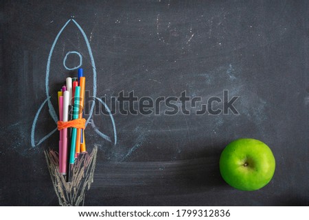 Chalk drawing of a rocket on the background of the blackboard. Back to school