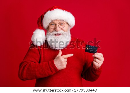 Best choice for x-mas wish dream gift buy payment. Old white grey hair beard man in santa claus headwear point finger credit card wear sweater jumper isolated bright shine color background