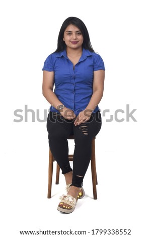portrait of a latein woman sitting on a chair on white background,