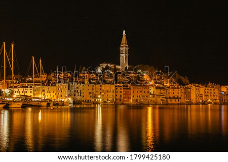 Rovinj,Istria,Croatia.View of night city situated on the coast of Adriatic Sea.Popular tourist resort and fishing port.Old town with cobblestone streets, colorful houses and Church of St. Euphemia