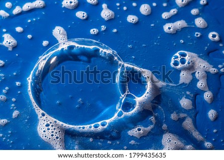 soap foam on a blue background - macro photography