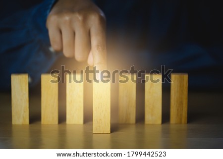 Human hand points at the front blocks wood  tor show influence and leadership, Concept business leadership for leadership teams, winners, successful people, and influential leaders.

 Royalty-Free Stock Photo #1799442523