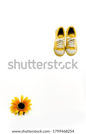a picture of yellow sneakers and sunflower